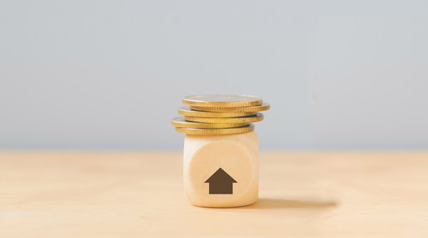 Small stack of coins on a wooden dice